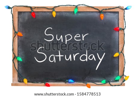 Super Saturday written in white chalk on a black chalkboard surrounded by festive colorful lights isolated on white
