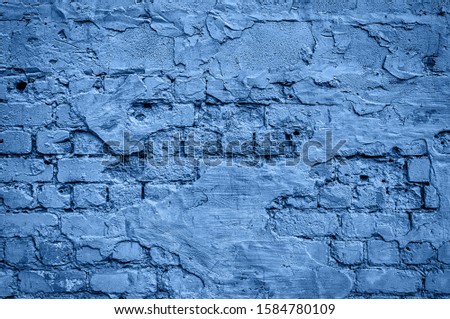 Grunge brick wall texture, copy space. CLassic blue background. Color of the year 2020. Top view, flat lay