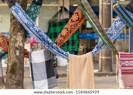 Brazilian handicraft. Sleeping nets made by northeastern artisans and displayed for sale in the candeiro of a Brazilian city avenue. Hammocks used in beach houses and summer seasons.