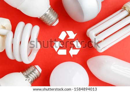 Spent incandescent halogen, cfi fluorescent, led, lumens light and energy saving bulbs tube, red background, Recycling sign. Lamps containing mercury - extremely hazardous waste. Close up.  