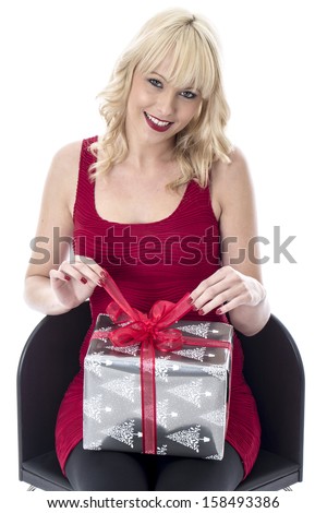 Model Released. Attractive Young Woman Holding a Christmas Present