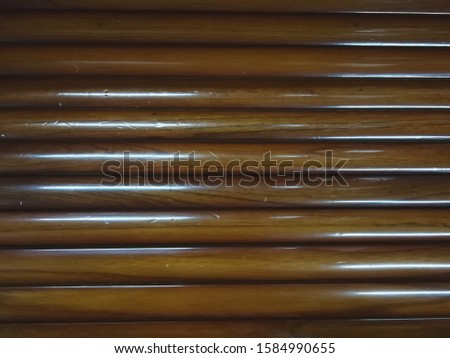 Wood grain background.The wood is brown and yellow spokes.
There is a light shadow of the bark. Lacquer coating