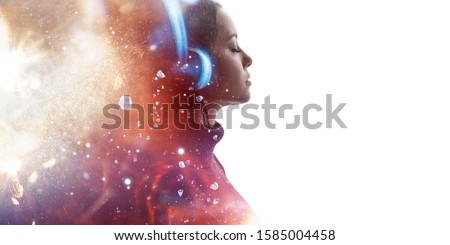Portrait of woman in headphones listening music with closed eyes. Double exposure of female face and light flare isolated on white background. Digital art. Blue neon light. Free space for text. Royalty-Free Stock Photo #1585004458
