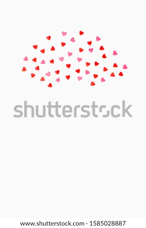 small sweet hearts lie in a semicircle on a white background. vertical photo. Flat lay. Copy space