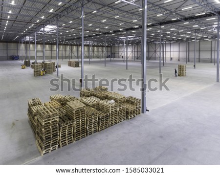 A modern warehouse with workers working with industrial items