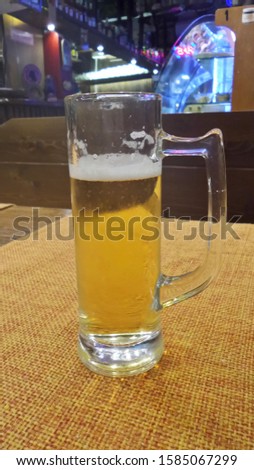 Funny picture of a mini beer served in tourist trap Venice, Italy, small beer glass, tiny portion served in a bar, rip off
