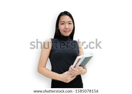 College Girl Holding Book Standing on White background. Portrait of young Asia woman student with smiling looking at camera.  isolated on white background