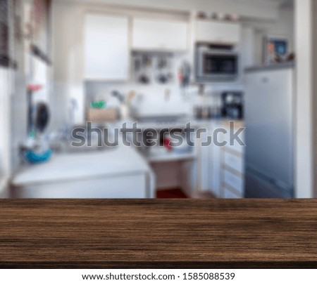 Wood table top on blur kitchen room background .For montage product display or design key visual layout.