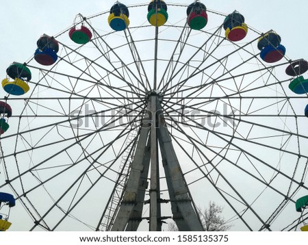 The photograph shows a very old Ferris wheel, which has been in operation for over sixty years.