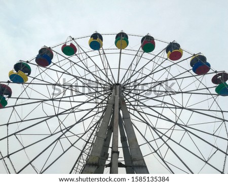 The photograph shows a very old Ferris wheel, which has been in operation for over sixty years.