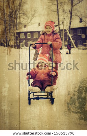 Kids skating and sledding in winter outdoors in a grunge style.