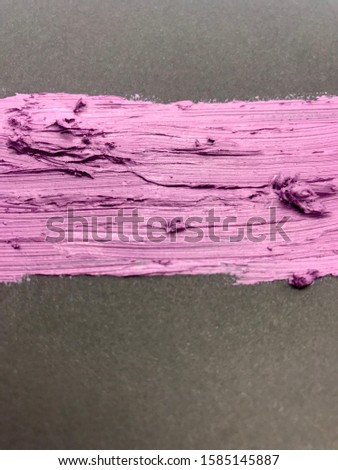 This is a photograph of a Metallic Shiny Purple Lipstick swatch on a Black background