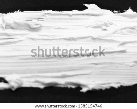 This is a photograph of a White Lipstick swatch isolated on a Black background