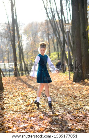 Young girl dancing and doing sports in autumn Park, Irish dance, fitness.