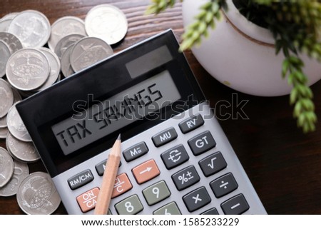 Calculator with text Tax Savings.  Business, finance conceptual.  Royalty-Free Stock Photo #1585233229