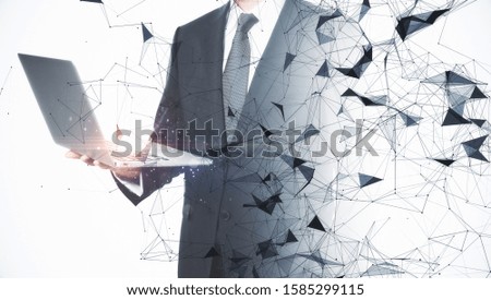 Businessman using laptop with creative digital polygons background. Technology and science concept. Multiexposure
