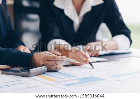 Businesswoman hand pen pointing on business document at meeting discussion and analysis data the charts and graphs showing the results at meeting.Business financial and accounting concept. Royalty-Free Stock Photo #1585316044