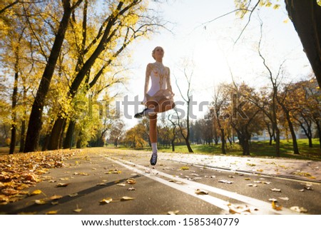 Young girl dancing and doing sports in autumn Park, Irish dance, fitness.