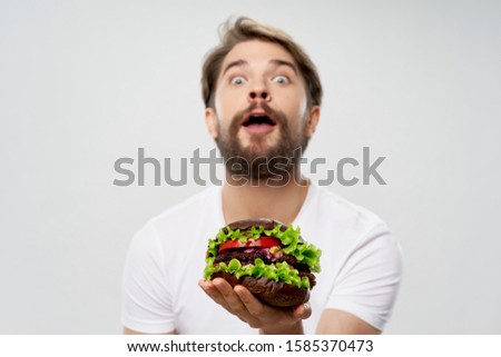 man with hamburger fast food diet snack closeup