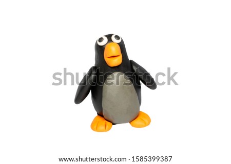 Statues like cute animals for children. Molding from plasticine. Cartoon characters, Penguin isolated on white background with clipping path.