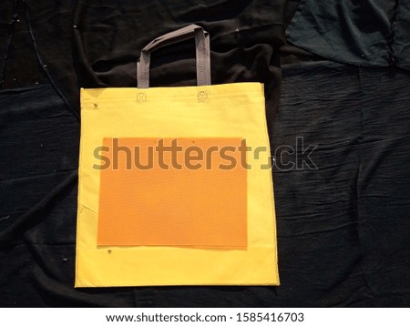 isolated yellow color shopping bags on black background 