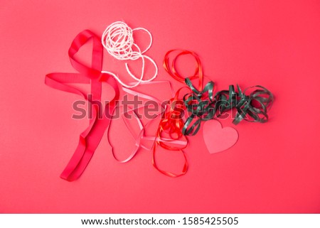 Colorful ribbons collection and heart shape on red background.