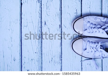 white sneakers on a light wooden background