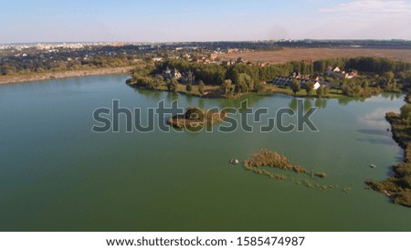 Flying over autumn drone lake aerial photography. Autumn east europe lakeside private houses.