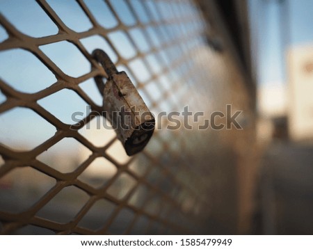 Love locks padlocks on bridge fence during sunset warm color