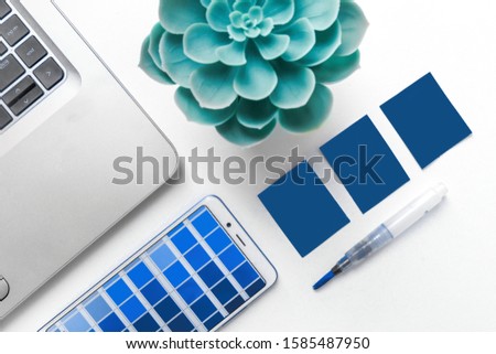 designer's desk, palette and laptop. color of the year 2020 classic blue pantone