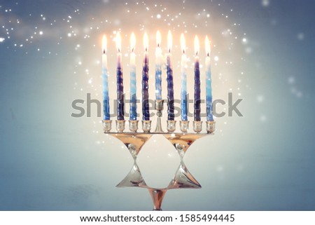 Religion image of jewish holiday Hanukkah background with david star menorah (traditional candelabra) and candles