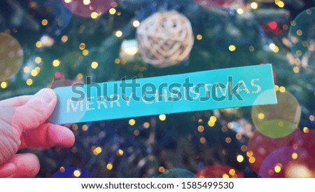 A green Tag with a golden Merry Christmas on It as Christmas Background