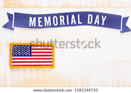 Chevron with USA flag and text MEMORIAL DAY on wooden background