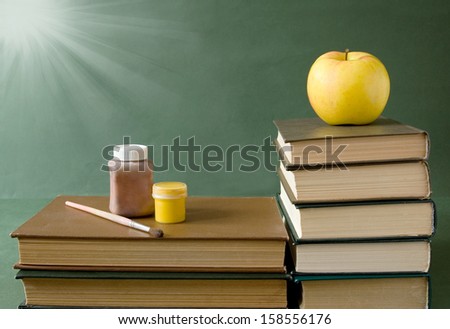 Teacher Day (still life with books, blackboard and apple)