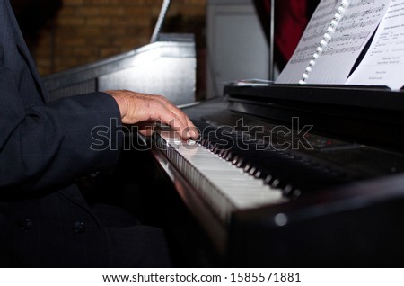 Closeups of someone playing the piano