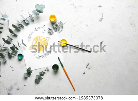 Artist's painting and supplies on light background