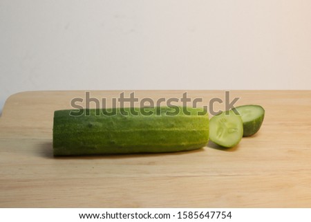 Green Cucumber Vegetable Fruit Isolated. Top view arrangement with sliced cucumbers.  Cucumber sliced on the cutting board, Top view with copy space. 