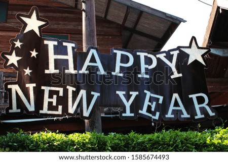 The word "Happy New Year" decorated in front of the ancient house