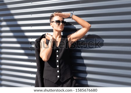 Model woman in sunglasses poses for the camera