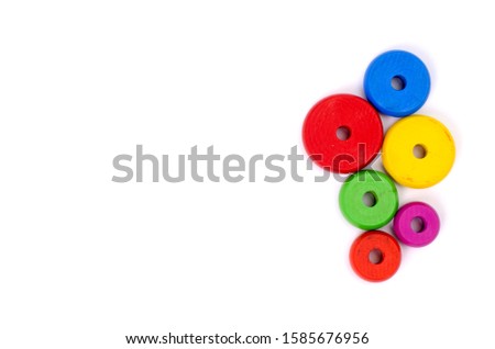 Wooden toys are red, green, yellow, and blue. Many numbers arranged beautifully.Red round wood Captured by hand.isolated a white background.Copy space.