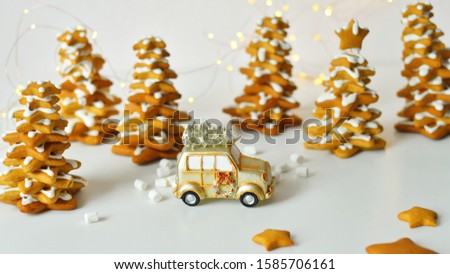 Christmas card with toy retro car ,with bokeh New Year's lights. . Cozy christmas with gingerbread cookies, cinnamon, cardamom
