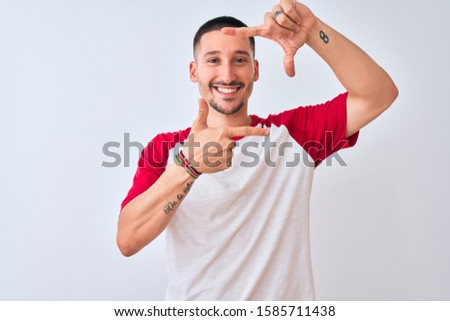 Young handsome man standing over isolated background smiling making frame with hands and fingers with happy face. Creativity and photography concept.