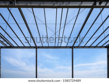 The roof structure lines is made of steel with blue sky