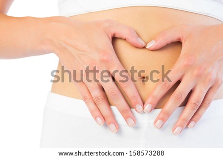 Close up picture of fit woman holding her belly on white background