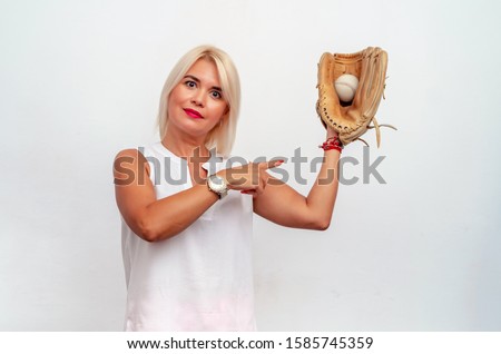 woman in a white blouse caught a baseball ball with a glove.