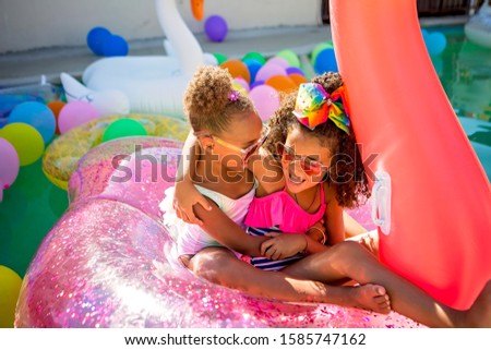 Summer fun cute little girl on inflatable