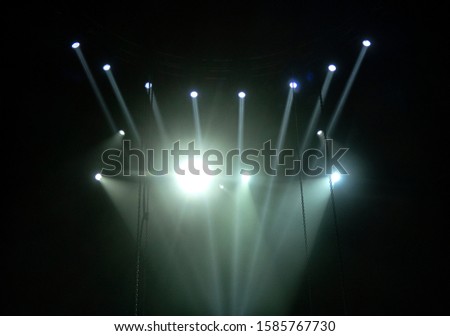 lighting equipment at concert - colored spotlights on ceiling in smoke, leaving room for showcased content.
