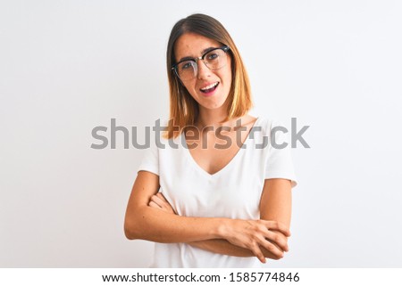 Beautiful redhead woman wearing glasses over isolated background happy face smiling with crossed arms looking at the camera. Positive person.