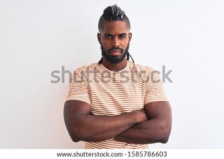 African american man with braids wearing striped t-shirt over isolated white background skeptic and nervous, disapproving expression on face with crossed arms. Negative person.