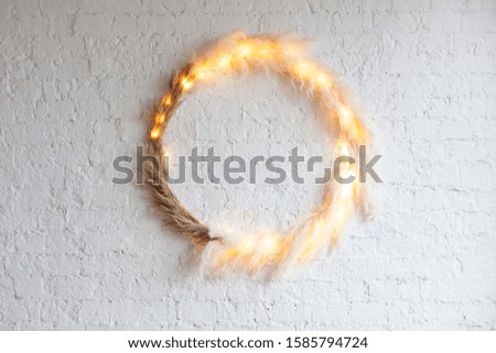 Incredible Scandinavian style decorative ring on a white wall with backlight.